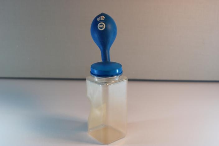 inflated balloon on plastic jar